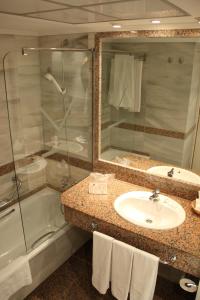 a bathroom with a sink and a shower at VIK Hotel San Antonio in Puerto del Carmen