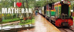 een trein op het spoor met een bord dat marathi ram leest bij Bluestar cottage in Matheran