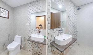 a bathroom with a sink and a toilet and a mirror at FabHotel The Gahmar Inn in Lucknow