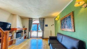 a living room with a couch and a tv at Cianfuran Panorama - Maison dOc in Bardonecchia +29 photos