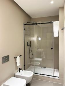 a bathroom with a shower and a toilet and a sink at Appartamenti Torrearsa street 35 in Trapani