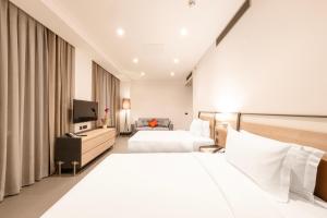 a hotel room with two beds and a television at Bomonti Arjaan by Rotana in Istanbul