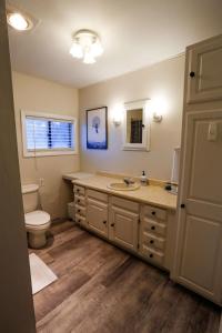 a bathroom with a sink and a toilet at Modern & Cozy Getaway House near Conway lake - Pet Friendly in Conway