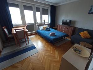 Ένα ή περισσότερα κρεβάτια σε δωμάτιο στο Apartament przy Ergo
