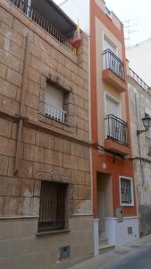 a brick building with two windows and a balcony at Casa Dúplex Kentia in Crevillente