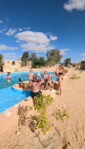 a group of women in bathing suits on the beach at Cafour House Siwa - Hot Spring in Siwa +70 photos