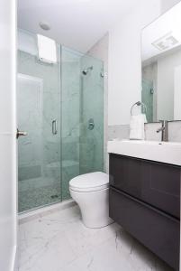 a bathroom with a toilet and a glass shower at Stylish Studio in Historic Boston - Unit #209 in Boston