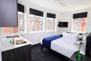 a hotel room with a bed and a sink at Modern Studio in Historic Boston - Unit #302 in Boston