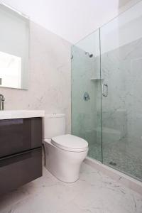 a bathroom with a toilet and a glass shower at Modern Studio in Historic Boston - Unit #302 in Boston
