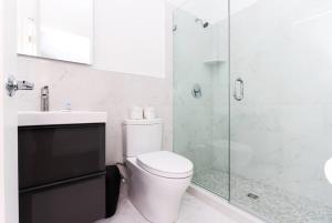 a bathroom with a toilet and a glass shower at Modern Studio in Historic Boston - Unit #403 in Boston