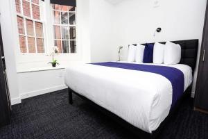 Cette chambre comprend un grand lit blanc et une fenêtre. dans l'établissement Stylish Stay in Fenway Neighborhood - Unit #304, à Boston