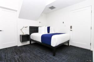 a bedroom with a bed with a blue and white blanket at Stylish Studio in Historic Boston - Unit #405 in Boston