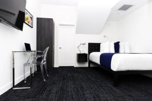 a hotel room with a bed and a desk at Stylish Studio in Historic Boston - Unit #405 in Boston