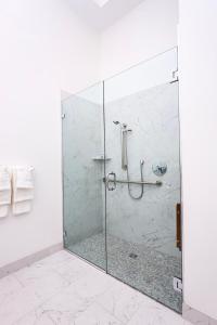 a shower with a glass door in a bathroom at Luxurious Studio in the Heart of Boston in Boston