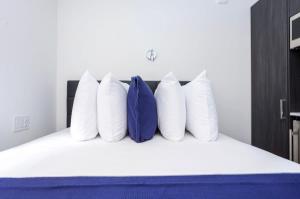 a group of pillows sitting on top of a bed at Modern Studio in Historic Boston - Garden Unit #2 in Boston