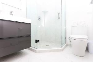 a bathroom with a toilet and a glass shower at Stylish Studio in Historic Boston - Unit #404 in Boston
