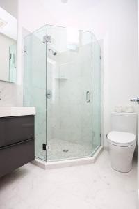 a bathroom with a glass shower and a toilet at Stylish Studio in Historic Boston - Unit #404 in Boston
