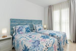 En eller flere senge i et værelse på Deluxe 2 bed Apartment + 36 billeder