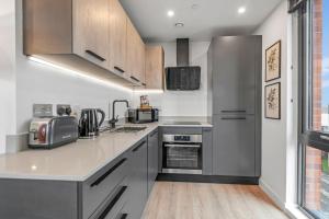 a kitchen with stainless steel appliances and wood floors at Apartment 47 with Free Secure Parking and Onsite Gym in York