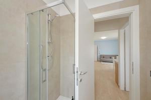a bathroom with a shower with a glass door at Andrea home- Collegato a Roma e Aeroporto in Fiumicino +35 photos