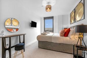 a bedroom with a bed and a desk and a window at Apartment 47 with Free Secure Parking and Onsite Gym in York