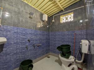 a bathroom with a toilet and a sink at Vijay Homestay in Dhordo