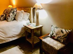 a bedroom with a bed and a table with a chair at Rolbos Accommodation in Beaufort West