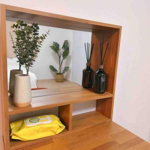 a shelf with vases and potted plants on it at Yudama Gangneung in Gangneung