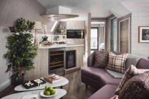 a living room with a couch and a table at Ardlui Retreat Lodge 7 in Arrochar