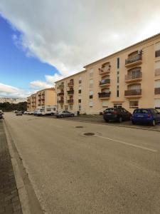 un estacionamiento con autos estacionados frente a un edificio en Quinta das Oliveiras 4 Bedrooms with Balcony, en Portimão