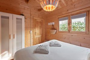 a bedroom with a white bed in a wooden room at The Sea Lodge in Zandvoort