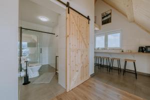a bathroom with a sliding door with a shower and a sink at Apartamenty widokowe Zakopane in Zakopane +96 photos