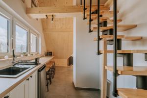 a kitchen with a spiral staircase in a tiny house at Apartamenty widokowe Zakopane in Zakopane