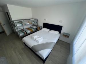 a bedroom with a bed and a shelf with towels at Hotel Le Cormier 9 in Cholet