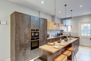 a large kitchen with a wooden counter and a table at Rawlinson Road 10B in Oxford