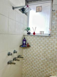 a bathroom with a shower and a window at Guru Mehar in Ludhiana
