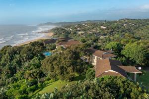 an aerial view of a house next to the ocean at Albatross Guesthouse in Southbroom