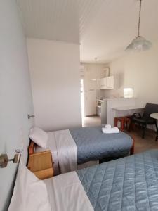 a hotel room with two beds and a kitchen at Nikos Apartments in Acharavi