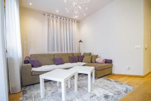 a living room with a couch and a table at Luxury Kalman Centar Apartmani in Zlatibor