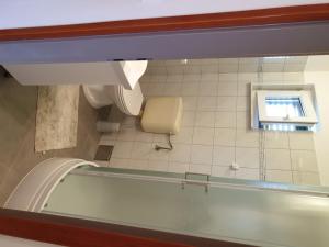 a bathroom with a tub and a toilet and a window at Seaview in Vrboska