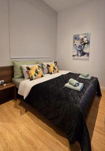 a bedroom with a large bed with towels on it at Tesla Boutique Apartments & Rooms in Zagreb