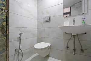 a bathroom with a toilet and a sink at Ratandeep International in New Delhi