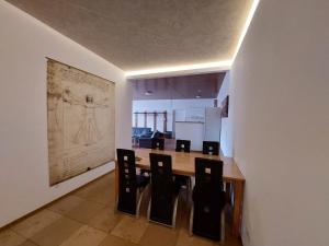 a dining room with a table and black chairs at Gästehaus Walter in Hardt