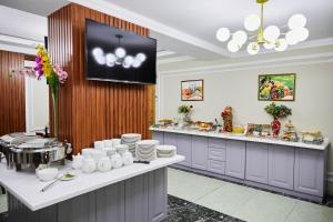 a kitchen with a counter with plates and dishes at Art Plaza Hotel in Tashkent
