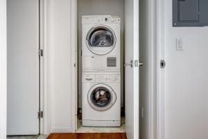 a washer and dryer sitting in a room at Blueground Hells Kitchen gym wd nr museum NYC-1436 in New York
