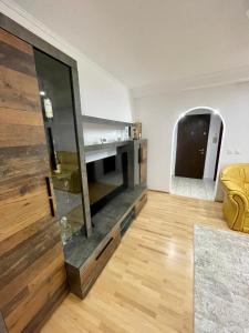 a living room with a fireplace and a couch at Central Cozy Apartament Near Monastery in Suceava