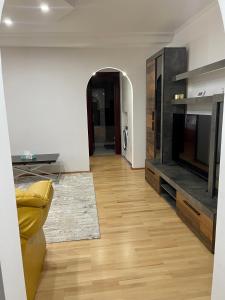 a living room with a fireplace and a television at Central Cozy Apartament Near Monastery in Suceava