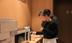 a man and a woman standing in front of a microwave at From H Ace Hotel Daejeon by Aank in Daejeon