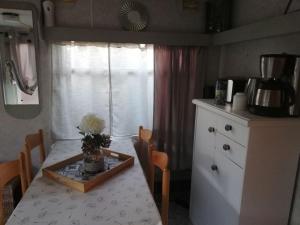 eine Küche mit einem Tisch und einer Blumenvase darauf in der Unterkunft Conteneur maritime in Ambon