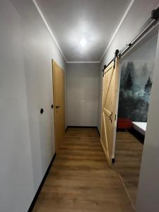 an empty hallway with a door and a wooden floor at APARTAMENT z widokiem na stadion. Styl Industrialny . Jedyny TAKI in Poznań